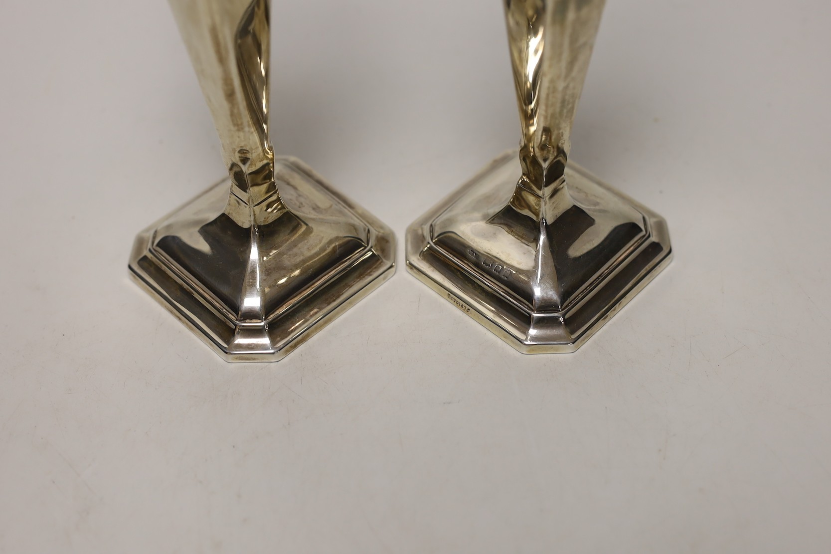 A pair of George V silver mounted candlesticks, London, 1925, height 22.5cm, weighted.